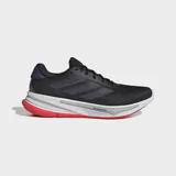 Championes de running Adidas Supernova Ease, color negro con detalles en violeta y suela blanca con detalles en rojo.