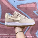 Zapatillas Nike Air Force 1 color beige con detalles en crema, suela blanca y base color caramelo.