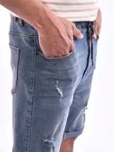 Bermuda de jean color celeste con roturas y cordón ajustable en la cintura.