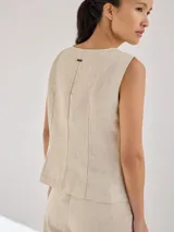 Chaleco color beige de lino con corte entallado y cierre frontal con botones de madera.