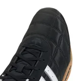 Zapatillas Adidas Adi Racer Lo negras con diseño acolchado, tres tiras blancas en los laterales y suela de goma color caramelo.