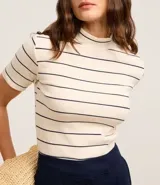 Blusa de ribana color crudo con rayas horizontales azul marino, cuello medio y mangas cortas.