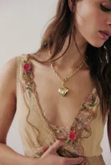 Vestido midi color crema con breteles finos, escote en V con encaje y bordado de flores rosas. Falda con terminación en encaje. Incluye forro.