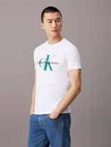 Remera blanca de corte slim, cuello redondo y mangas cortas. Estampado frontal con el logo de Calvin Klein Jeans en verde y negro.