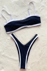 Bikini cavada en dos tonos, negro con detalles en blanco, con forrado interior, relleno desmontable y tiras regulables.