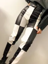 Pantalón de cuero con diseño a cuadros en blanco y negro, de corte ajustado.