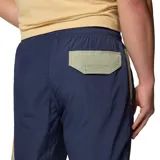 Pantalón largo de hombre Columbia, modelo Challenger Windbreak, color azul marino con detalles en naranja y bolsillo con cierre en el muslo.