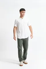 Camisa blanca de manga corta con cuello mao y doblez en las mangas.