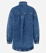 Camisa oversized de jean azul, con cuello padre, mangas largas con puños abotonados y cierre frontal con botones. Incluye un bolsillo aplicado en el pecho y bajo redondeado.