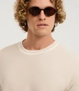 Remera de hombre, corte regular, color beige claro con cuello redondo y ribetes en contraste en el cuello y los puños de las mangas cortas.