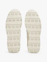 Zapatillas Tommy Jeans de estilo running, color blanco hueso, con exterior de ante, interior de poliéster y suela gruesa de goma con tacos. Presentan paneles con mezcla de texturas y detalles distintivos de la marca.