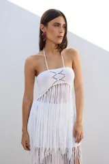 Top tejido de algodón color negro, con espalda descubierta y terminación en flecos.