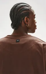 Remerón marrón chocolate de corte extra oversize con hombros caídos, cuello redondo de rib al tono y doble costura.