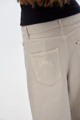 Pantalón jean de corte ancho, color beige claro.