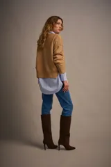 Camisa celeste a rayas verticales blancas, de corte oversize, manga larga y puños anchos.
