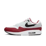 Championes Nike Air Max 1 de hombre, color blanco, gris y rojo, con logo negro en el lateral.