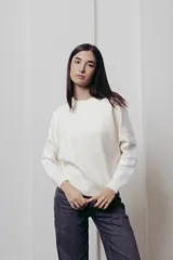 Sweater negro de punto con mangas largas y paneles de lentejuelas plateadas en los hombros y brazos.