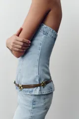 Top strapless de denim celeste con escote recto y cierre trasero con cremallera.