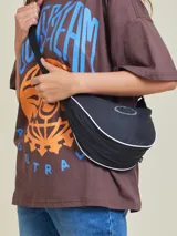 Bandolera negra con correa de tela regulable.