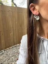 Aros pequeños plateados con forma circular, hechos de resina y strass.