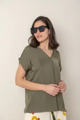 Blusa fucsia de seda con escote en V y mangas cortas.