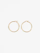 Aros tipo argolla extra grandes de acero quirúrgico hipoalergénico color dorado.