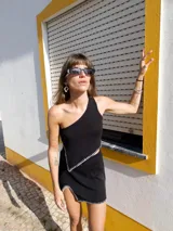 Top tejido negro de algodón con breteles finos y pespuntes blancos.