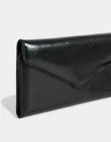 Billetera negra tipo sobre de cuerina con solapa y correa lateral desmontable con tachas plateadas.