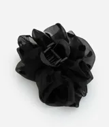 Pinza para el pelo negra con revestimiento de tela de poliéster con estampado de lunares.