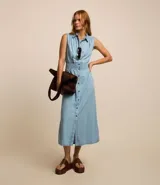 Vestido midi de jean celeste, sin mangas, con cuello camisero, abotonado al frente y con lastex en la cintura.