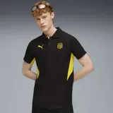Polo de fútbol Puma color negro con detalles en amarillo, escudo del Club Atlético Peñarol y logo de Puma bordados.
