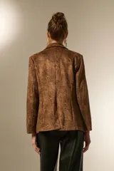 Blazer de poliéster con estampado animal print en tonos marrones y negros, de corte holgado, con cuello solapa y cierre frontal de doble botonadura.