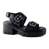 Sandalias negras de plataforma con hebillas plateadas y suela track.