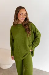 Pantalón largo verde con textura de tejido trenzado.