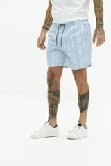 Short de baño largo azul con estampado abstracto de hojas en tonos azules más claros. Posee cintura elástica con cordón de ajuste gris, bolsillos laterales y un bolsillo trasero.