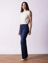 Jean bootcut de tiro alto, marca Baccini. Modelo de pierna recta y terminación bootcut. Pretina con pasadores, botón y cierre. Delantera y trasera con bolsillos.