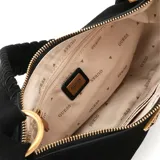 Bolso de hombro tipo media luna, color negro, con acabado de gamuza o material similar. Presenta un cierre superior con cremallera y un logo triangular metálico de Guess en color dorado en el frente. La correa de hombro es negra y trenzada.