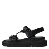 Sandalias negras de plataforma con tiras de cuero sintético y apliques metálicos.