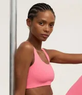 Top deportivo blanco de poliamida, sin copa, sin estampa y con escote redondo.