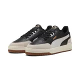 Championes Puma Shuffle Downtown OG de cuero sintético negro con detalles en blanco y beige.