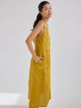 Vestido midi rojo de lino, sin mangas y con cuello redondo.