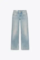 Jeans de tiro bajo y cinco bolsillos, color celeste claro con efecto lavado. Pierna ancha extra larga. Cierre frontal con cremallera y botón metálico.