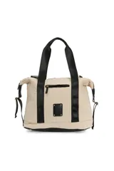 Bolso tipo duffle color beige con diseño acolchado, doble asa de mano negra y base negra.