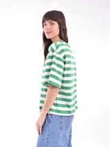 Remera blanca con rayas horizontales rojas, de corte holgado y mangas cortas.