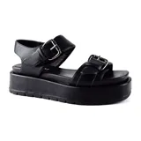 Sandalias negras con plataforma, tiras anchas con hebillas plateadas y ajuste con hebilla al tobillo.