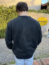 Buzo negro de algodón con efecto lavado y logo bordado en el pecho.