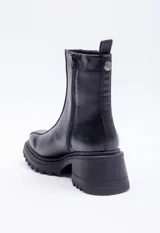 Bota en símil cuero color tostado, con punta redonda y plataforma tipo tractor de 6 cm.