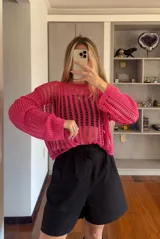 Buzo tejido de hilo color fucsia, con mangas largas y calado.