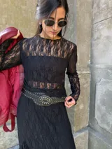 Remera de encaje negro con mangas largas, cuello redondo y corte ajustado.