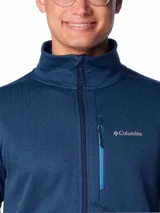 Campera polar Columbia Park View Fleece, color azul jaspeado, con cierre frontal completo, cuello alto, bolsillos laterales con cierre y bolsillo en el pecho con cierre vertical en color verde lima. Cuenta con tecnología Omni-Wick, puños elásticos con orificios para pulgares y protector de barbilla.